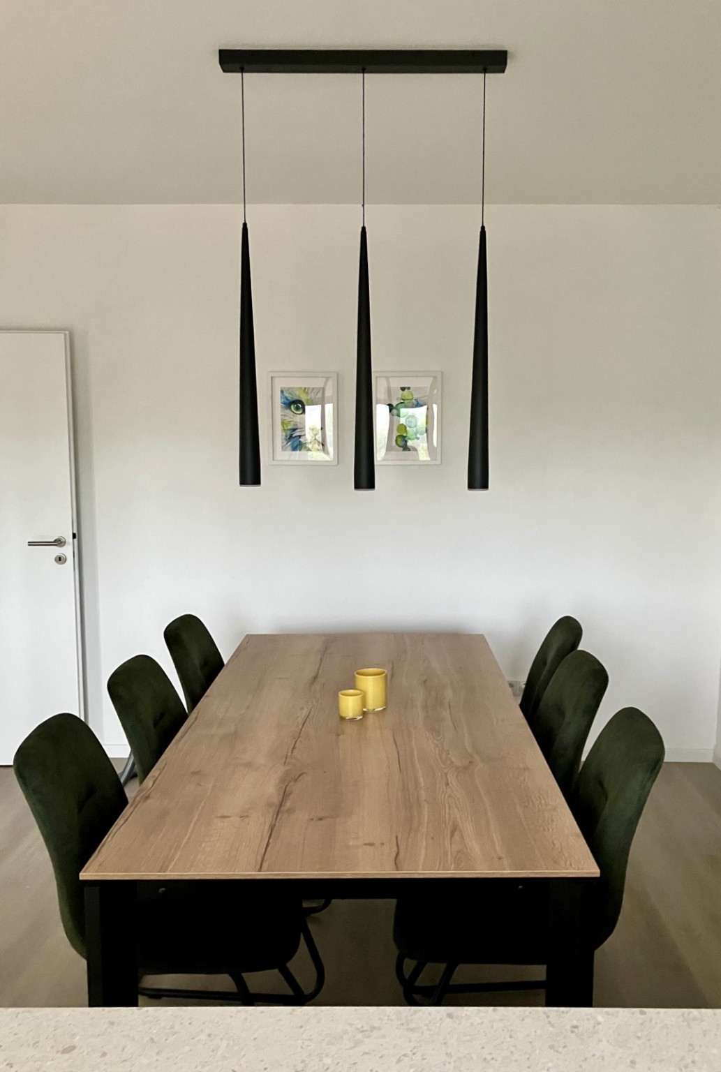 Zum Vergrößern anklicken Großer Esstisch mit sechs Stühlen und moderner Pendelleuchte